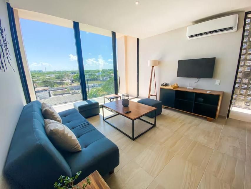 Living room with sofa bed, TV and big windows